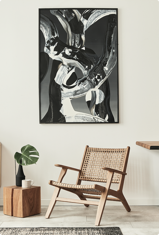 Room with black and white artwork and wooden chair